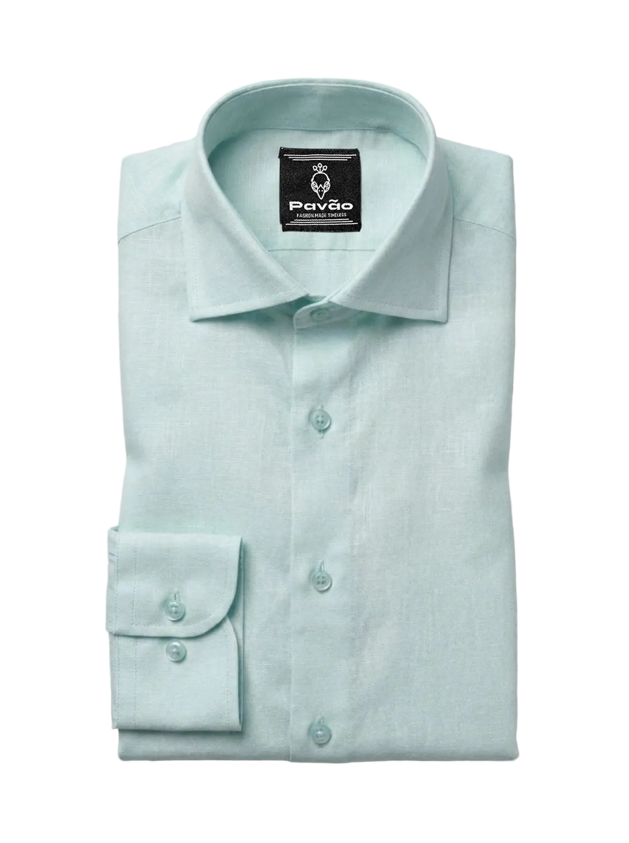 A folded light mint green dress shirt by Pavão, featuring a classic collar, button-down front, and a single-button cuff, displayed on a neutral light gray background.