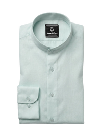 A folded light mint green dress shirt with a band collar and a single-button cuff, displayed on a neutral light gray background. The brand label 'Pavão' is visible inside the collar.