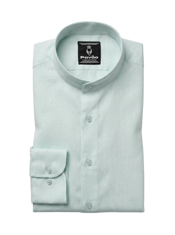 A folded light mint green dress shirt with a band collar and a single-button cuff, displayed on a neutral light gray background. The brand label 'Pavão' is visible inside the collar.