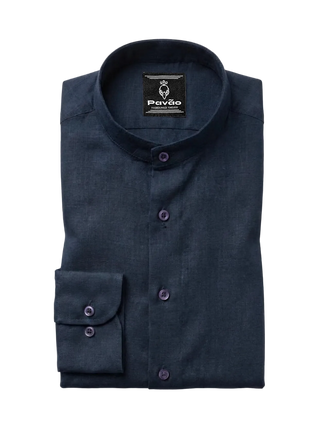 A folded dark navy blue long-sleeve dress shirt with a mandarin collar and purple buttons, shown on a light gray background. The brand label 'Pavão' is visible inside the collar.