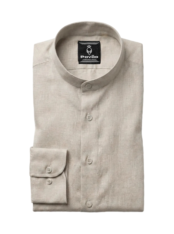 A folded light beige linen shirt with a mandarin collar and button-down front, featuring a brand label for 'Pavão' on the inside collar and a single buttoned cuff, shown on a light gray background.