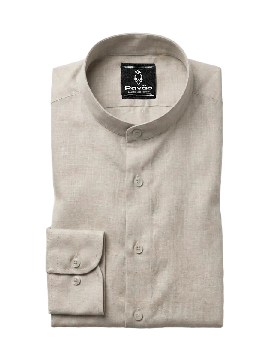A folded light beige linen shirt with a mandarin collar and button-down front, featuring a brand label for 'Pavão' on the inside collar and a single buttoned cuff, shown on a light gray background.