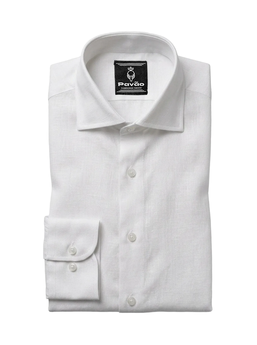 A folded white long-sleeve dress shirt with a spread collar and a single-button cuff, shown on a light gray background. The brand label 'Pavão' is visible inside the collar.