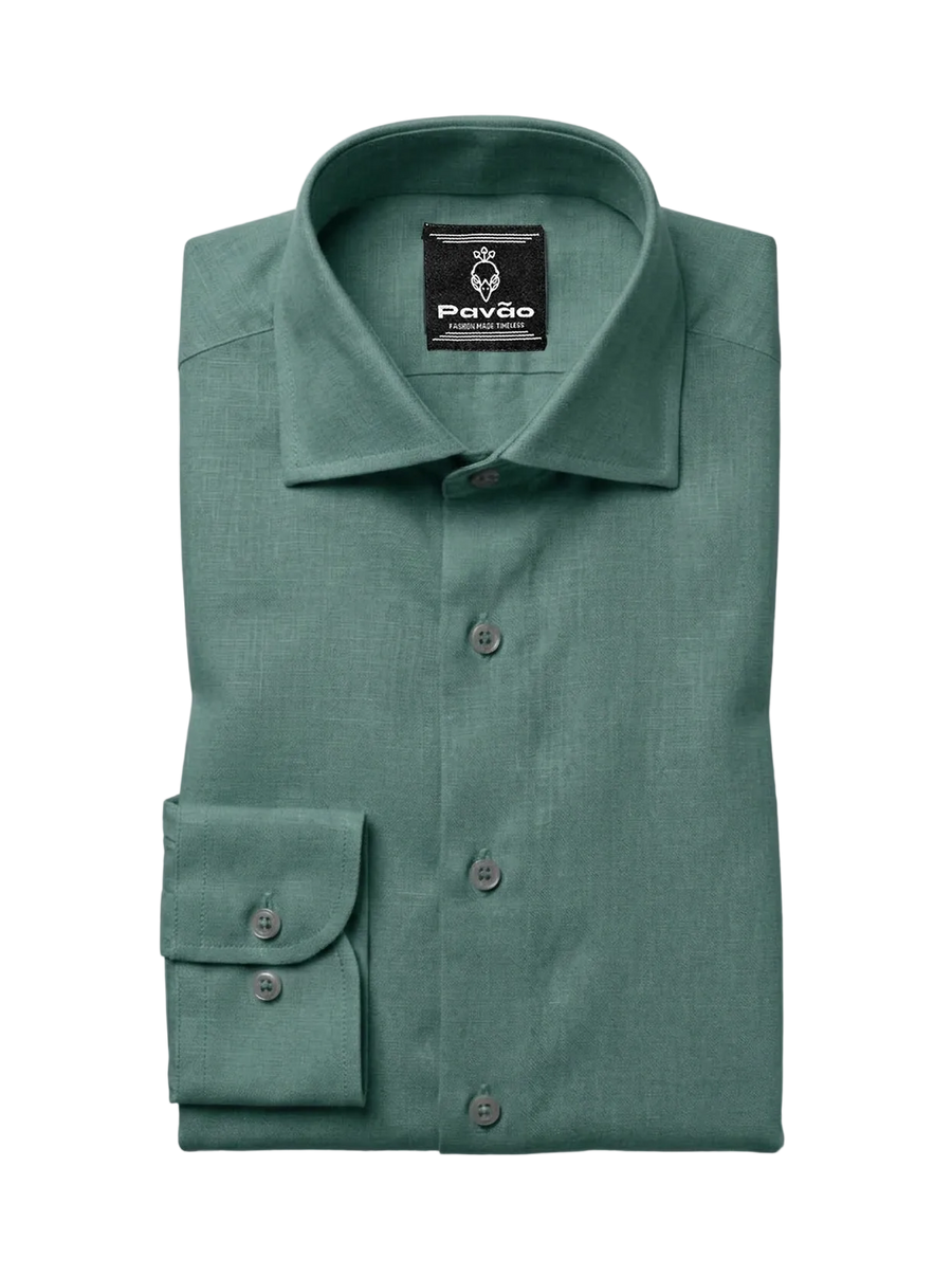 A folded sage green dress shirt with a spread collar and button-down front, featuring a brand label for 'Pavão' on the inside collar, set against a clean white background.