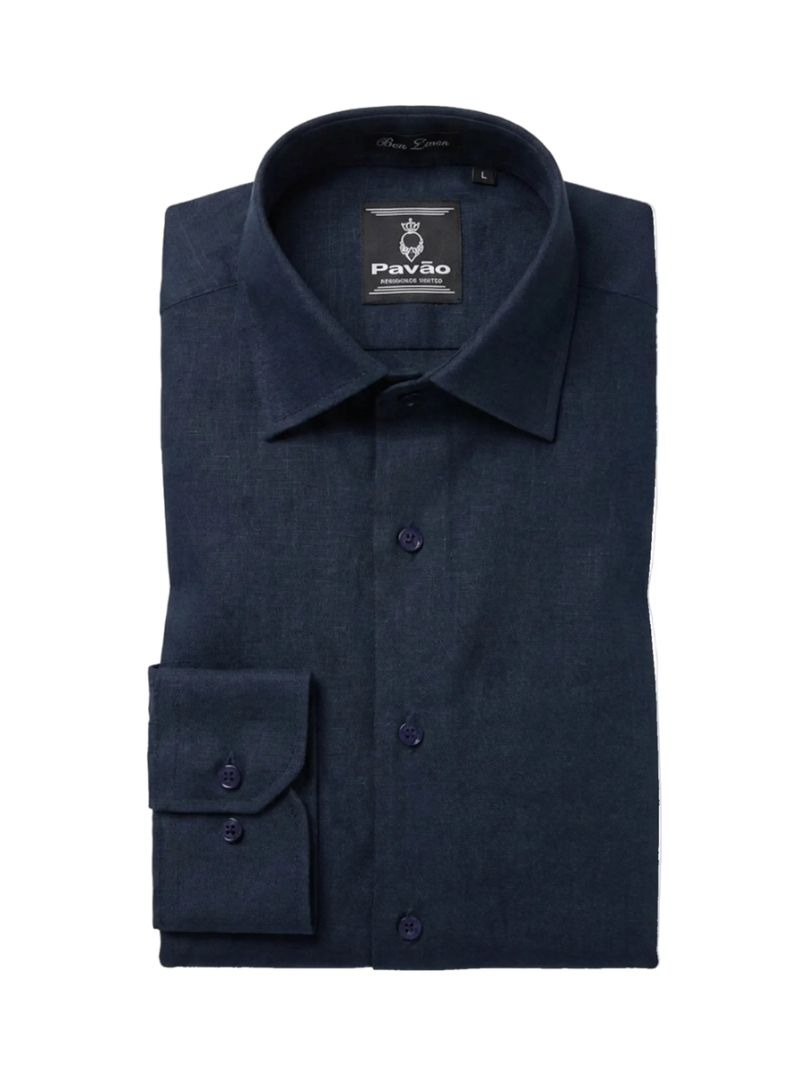 A folded dark navy blue long-sleeve dress shirt by Pavão, featuring a button-down front, pointed collar, and a single cuff with two buttons, shown on a plain white background.
