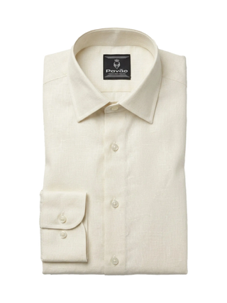 A folded cream-colored linen dress shirt with a spread collar and a buttoned cuff, displayed on a clean white background. The brand label inside the collar reads 'Pavão'.