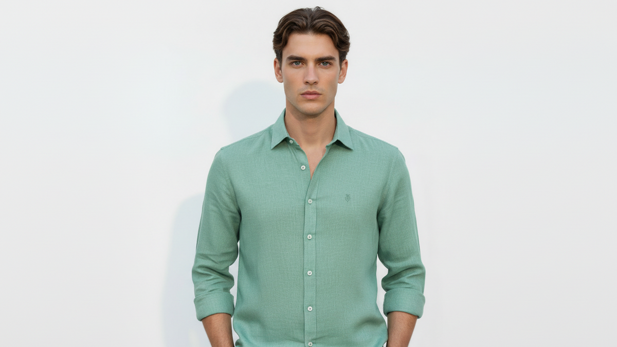 Man wearing a green linen shirt against a white background